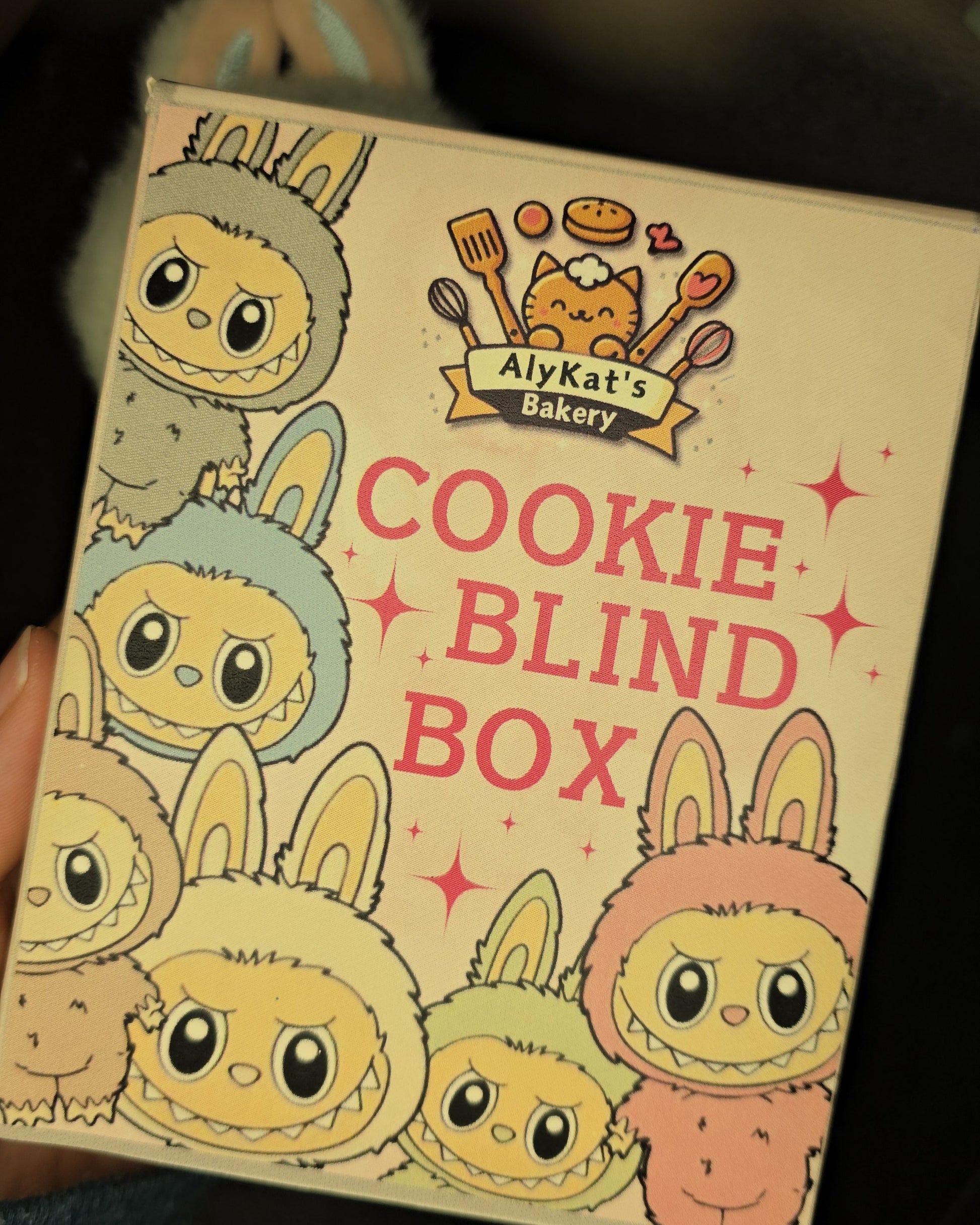 Cookie Blind Box packaging with cartoonish cookie designs on a dark background